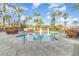 Outdoor community pool surrounded by lush landscaping and palm trees, perfect for relaxing in a tropical setting at 309 Verona Ave, Davenport, FL 33897