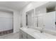 Elegant bathroom featuring double sinks, granite counters, and a walk-in shower at 349 Guadlupe St, Haines City, FL 33844