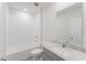 Pristine white bathroom featuring a vanity with gray cabinets and a shower-tub combination at 349 Guadlupe St, Haines City, FL 33844