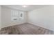 Bedroom featuring carpet floors, two windows allowing natural light, and neutral paint at 349 Guadlupe St, Haines City, FL 33844