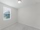 Bright, carpeted bedroom with a large window offering plenty of natural light at 349 Guadlupe St, Haines City, FL 33844