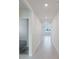 Bright hallway featuring recessed lighting and sleek wood-look flooring leading to various rooms at 349 Guadlupe St, Haines City, FL 33844