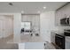 Bright kitchen with gray cabinetry, stainless steel appliances, and a large island with a sink at 349 Guadlupe St, Haines City, FL 33844