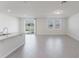 Open-concept living room boasting wood floors, ample natural light, and sliding glass door access at 349 Guadlupe St, Haines City, FL 33844