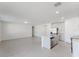 Open-concept living space with wood-look flooring, kitchen island, and stainless steel appliances at 349 Guadlupe St, Haines City, FL 33844