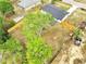 High aerial view of house with long driveway, fenced yard and mature trees at 358 Prevo Dr, Apopka, FL 32712