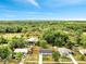 High aerial view of house in the neighborhood, with fenced backyard and many trees at 358 Prevo Dr, Apopka, FL 32712