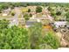 High aerial view of the house, surrounding fence, mature trees, and the neighborhood at 358 Prevo Dr, Apopka, FL 32712