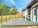 View of a large new wooden deck with railings overlooking the backyard and wooden fence at 358 Prevo Dr, Apopka, FL 32712