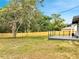 Large fenced backyard with a wooden deck, perfect for outdoor activities and privacy at 358 Prevo Dr, Apopka, FL 32712