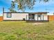 Spacious backyard featuring a wooden deck with metal railings, offering ample outdoor space at 358 Prevo Dr, Apopka, FL 32712