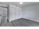 Bedroom with closet, gray wood floors, and white walls at 358 Prevo Dr, Apopka, FL 32712