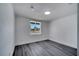Bright bedroom features gray wood floors, white walls, and a sunlit window at 358 Prevo Dr, Apopka, FL 32712