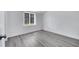 Bedroom featuring gray wood floors, white walls, and natural light at 358 Prevo Dr, Apopka, FL 32712