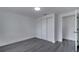 Bedroom with closet, gray wood floors, and white walls with white trim at 358 Prevo Dr, Apopka, FL 32712
