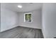 Bright room featuring gray wood floors, white walls, and a sunlit window at 358 Prevo Dr, Apopka, FL 32712