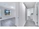 View of a hallway leading to a room and kitchen with light gray wood floors at 358 Prevo Dr, Apopka, FL 32712
