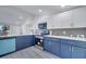 Bright kitchen featuring white and blue cabinets, stainless steel appliances, and sleek countertops at 358 Prevo Dr, Apopka, FL 32712