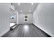 Open-concept living room with gray wood flooring, white trim, and a multi-step entryway at 358 Prevo Dr, Apopka, FL 32712