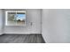 Bright living room with new gray flooring, baseboards, fresh paint and front window at 358 Prevo Dr, Apopka, FL 32712