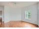 Bright bedroom with hardwood floors, a ceiling fan, and natural light streaming through the window create an inviting atmosphere at 3621 Conroy Rd # 738, Orlando, FL 32839