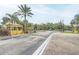Community entrance gate with guard house surrounded by lush landscaping and mature trees at 3621 Conroy Rd # 738, Orlando, FL 32839