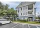 Attractive multi-story condo building with a parking lot, landscaping, and classic architectural details at 3621 Conroy Rd # 738, Orlando, FL 32839