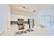 Modern kitchen featuring stainless steel appliances, white cabinets, and tiled backsplash at 3621 Conroy Rd # 738, Orlando, FL 32839