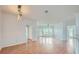 Sunlit living room featuring hardwood floors, neutral walls, and access to a balcony at 3621 Conroy Rd # 738, Orlando, FL 32839