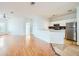 Open concept living room with hardwood floors connecting to the kitchen area at 3621 Conroy Rd # 738, Orlando, FL 32839