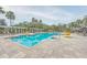 A refreshing outdoor pool area with palm trees and lounge chairs under a sunny sky at 3621 Conroy Rd # 738, Orlando, FL 32839