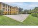 Exterior view of a sand volleyball court with net and well-manicured green surroundings at 3621 Conroy Rd # 738, Orlando, FL 32839