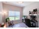 Cozy bedroom offering a window view, laminate floors, ceiling fan, and a functional workspace at 401 Harbor Winds Ct, Winter Springs, FL 32708