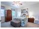 Traditional bedroom with decorative mirror, bench seat, and wood furniture at 401 Harbor Winds Ct, Winter Springs, FL 32708