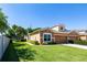 Inviting home featuring well-maintained lawn, manicured bushes, and a neutral color scheme with a two-car garage at 401 Harbor Winds Ct, Winter Springs, FL 32708