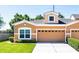 Charming townhome with well-manicured lawn, two-car garage, and neutral color scheme exudes curb appeal at 401 Harbor Winds Ct, Winter Springs, FL 32708