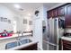 Well-appointed kitchen featuring stainless steel appliances, including a large refrigerator, and granite countertops at 401 Harbor Winds Ct, Winter Springs, FL 32708