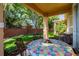 Charming covered patio featuring a decorative table set perfect for outdoor dining and enjoying the landscaped backyard at 401 Harbor Winds Ct, Winter Springs, FL 32708