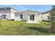 Exterior backyard view featuring grass and the rear facade of the home at 4224 Pebbles Throw Dr, Kissimmee, FL 34746