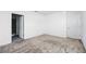 A bedroom with neutral carpet and walls, featuring access to the bathroom at 4224 Pebbles Throw Dr, Kissimmee, FL 34746