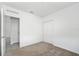 An interior bedroom view with a door, closet, and neutral carpet at 4224 Pebbles Throw Dr, Kissimmee, FL 34746
