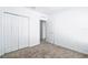 An interior bedroom view with a door, closet, and neutral carpet at 4224 Pebbles Throw Dr, Kissimmee, FL 34746