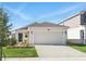 Charming single-Gathering home featuring a two-car garage, complemented by a well-maintained lawn and landscape at 4224 Pebbles Throw Dr, Kissimmee, FL 34746