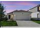 Charming single-Gathering home featuring a two-car garage, complemented by a well-maintained lawn and landscape at 4224 Pebbles Throw Dr, Kissimmee, FL 34746