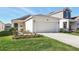 Charming single-Gathering home featuring a two-car garage, complemented by a well-maintained lawn and landscape at 4224 Pebbles Throw Dr, Kissimmee, FL 34746