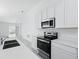 Modern kitchen with stainless steel appliances, and ample counter space at 4224 Pebbles Throw Dr, Kissimmee, FL 34746