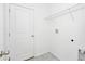 Bright laundry area with a door, tile floors, wire shelving, and washer/dryer hookups at 4224 Pebbles Throw Dr, Kissimmee, FL 34746