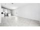 An expansive living area showcasing tile flooring, a kitchen, and abundant natural light at 4224 Pebbles Throw Dr, Kissimmee, FL 34746