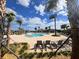 Large community pool with ample seating and lush landscaping provides a resort-style experience for residents at 4224 Pebbles Throw Dr, Kissimmee, FL 34746