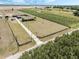 Aerial view of the property featuring green space, a home, a windmill, and a gate at the entrance at 4400 Walker Lake Rd, Bartow, FL 33830